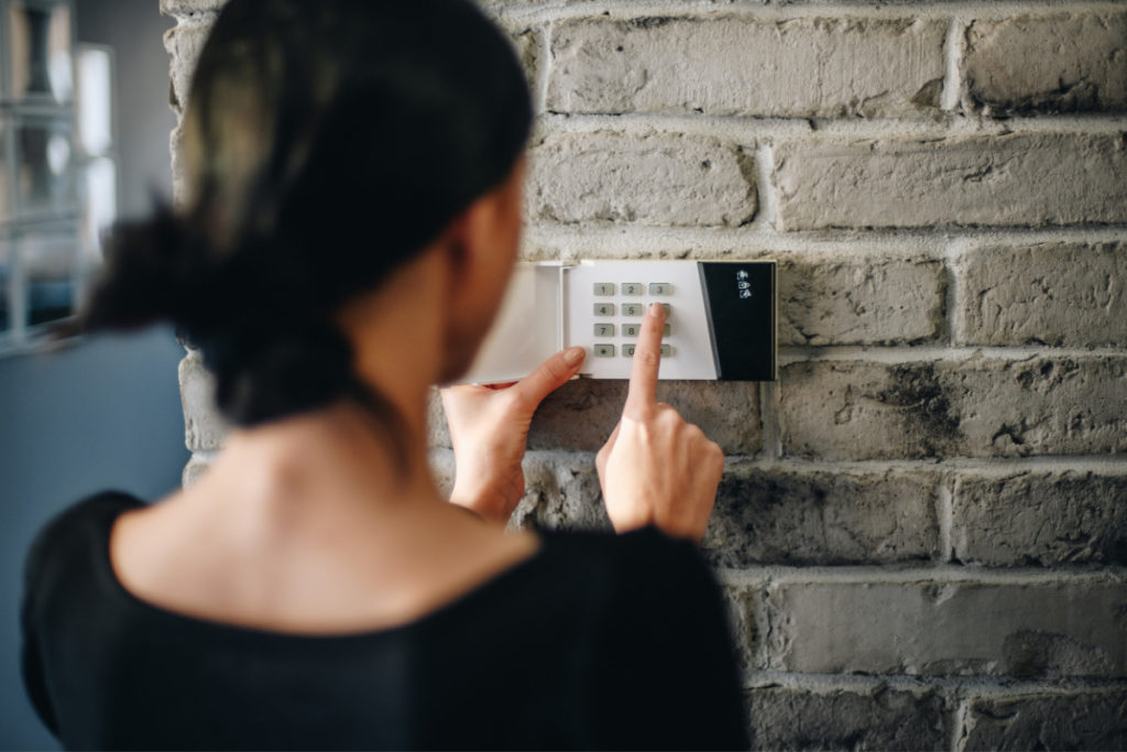 Lady setting home alarm system