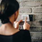 Lady setting home alarm system
